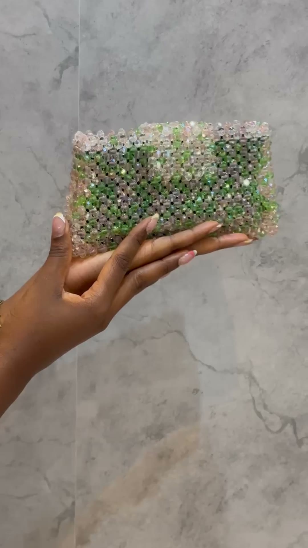 An emerald crystal-beaded clutch